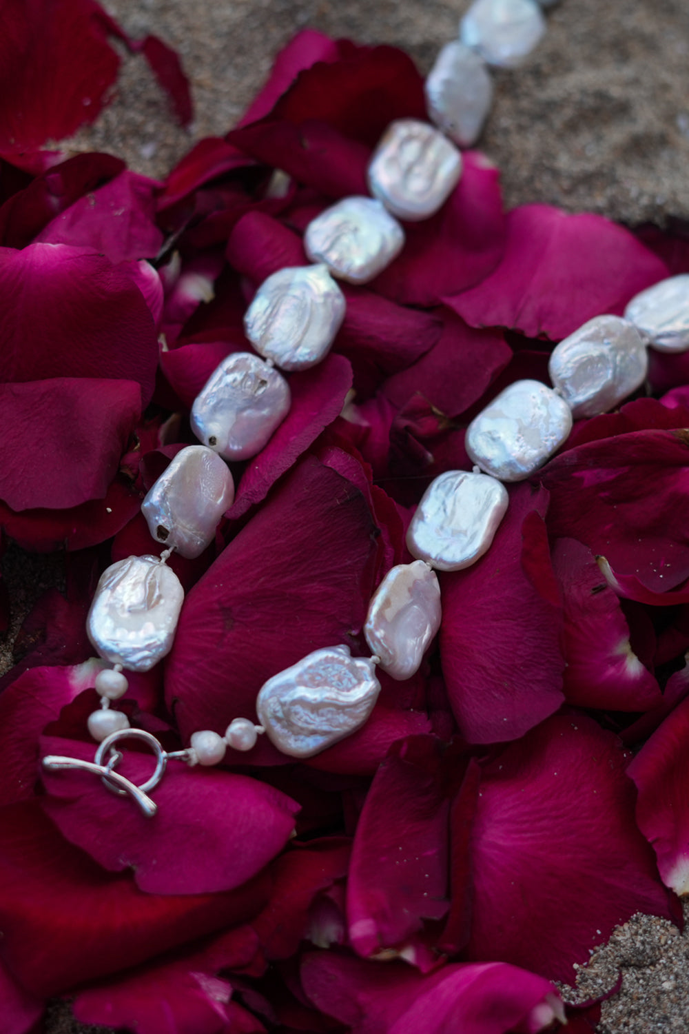 Discover the Moon Tide Necklace in Lunar Pearl, with irregular natural pearls and a gold toned toggle closure from Earth Altering by Jinx the Label.