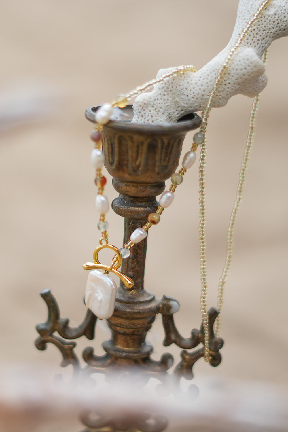 Shop the Moonwater Necklace in Pearl Gold, with delicate beads, organic pearls, gold toggle and a baroque pearl pendant from Earth Altering by Jinx the Label.