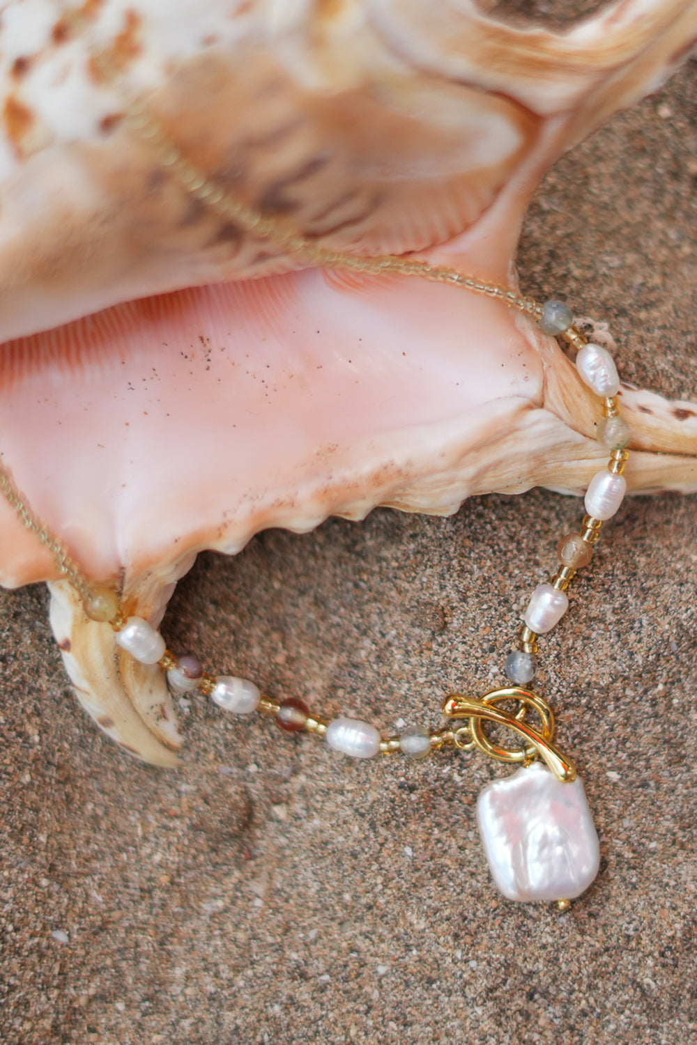 Shop the Moonwater Necklace in Pearl Gold, with delicate beads, organic pearls, gold toggle and a baroque pearl pendant from Earth Altering by Jinx the Label.