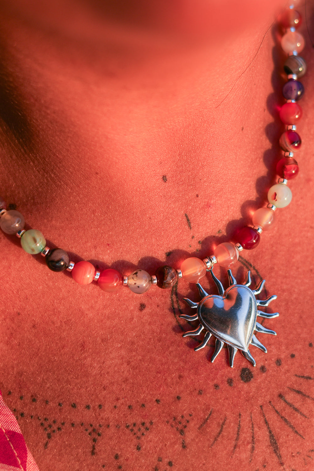 Meet the Sacred Flame Necklace in Wild Ember, with colorful natural stone beads and a statement silver heart pendant from Earth Altering by Jinx the Label.