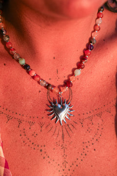 Meet the Sacred Flame Necklace in Wild Ember, with colorful natural stone beads and a statement silver heart pendant from Earth Altering by Jinx the Label.