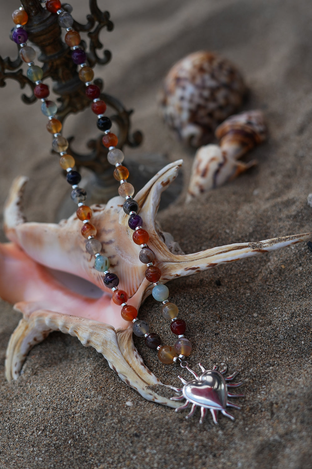 Meet the Sacred Flame Necklace in Wild Ember, with colorful natural stone beads and a statement silver heart pendant from Earth Altering by Jinx the Label.