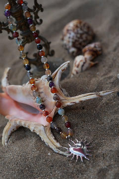 Meet the Sacred Flame Necklace in Wild Ember, with colorful natural stone beads and a statement silver heart pendant from Earth Altering by Jinx the Label.