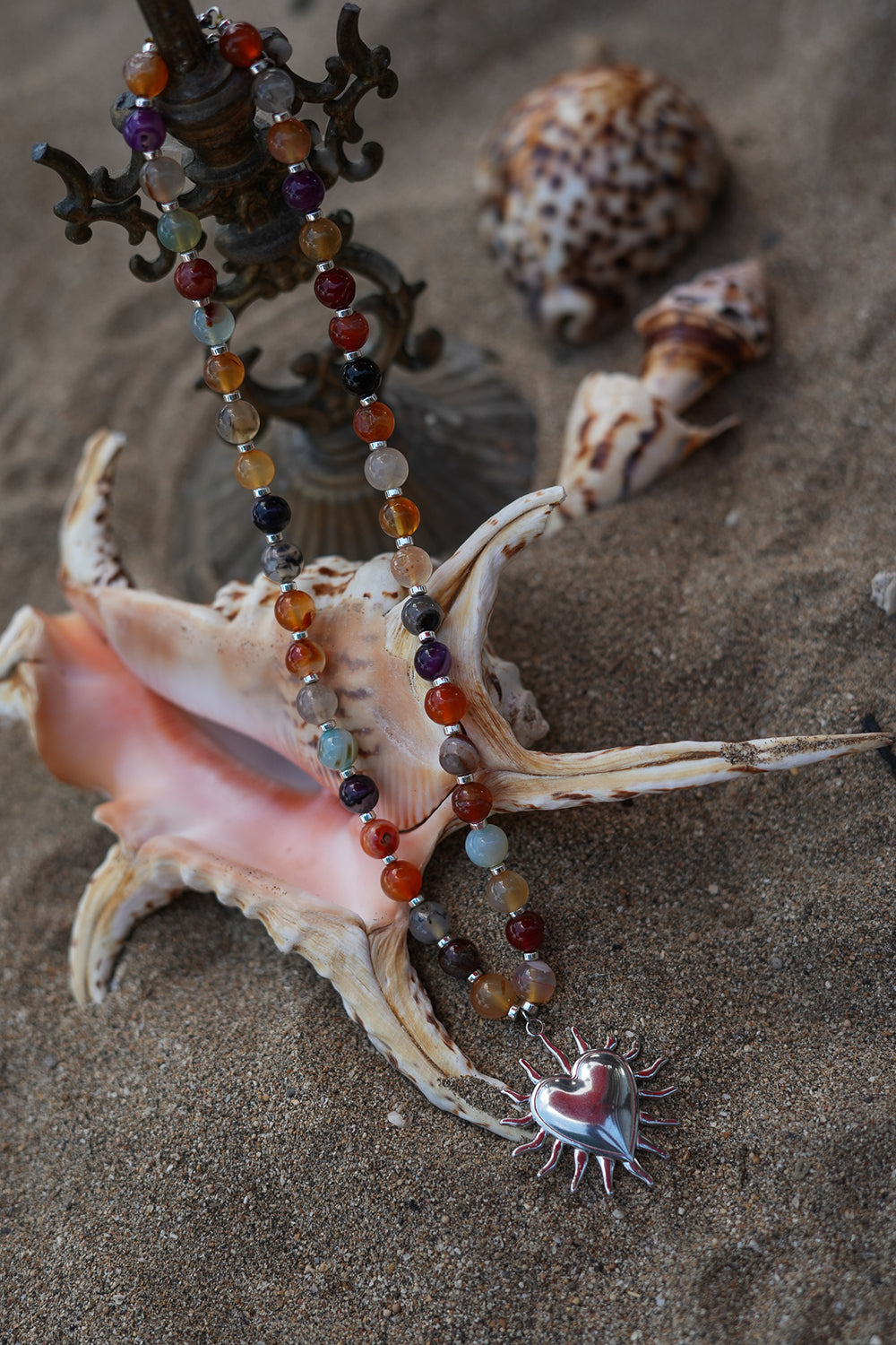 Meet the Sacred Flame Necklace in Wild Ember, with colorful natural stone beads and a statement silver heart pendant from Earth Altering by Jinx the Label.