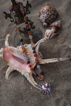 Meet the Sacred Flame Necklace in Wild Ember, with colorful natural stone beads and a statement silver heart pendant from Earth Altering by Jinx the Label.