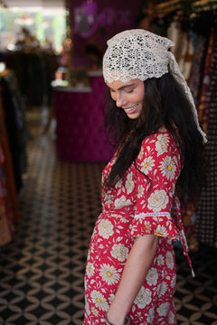 The Sienna Jumpsuit in Wild Daisy Rouge by Jinx the Label, soft rayon with lace sleeves, open back, waist tie and split leg pants for effortless style.