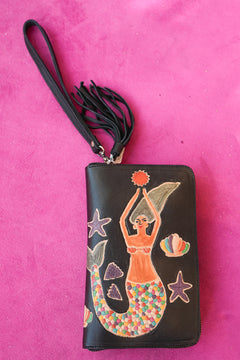 Meet the Siren Wallet in Midnight Black. A handcrafted leather zip wallet with a hand painted mermaid, card slots, coin compartment, wrist strap and tassel.