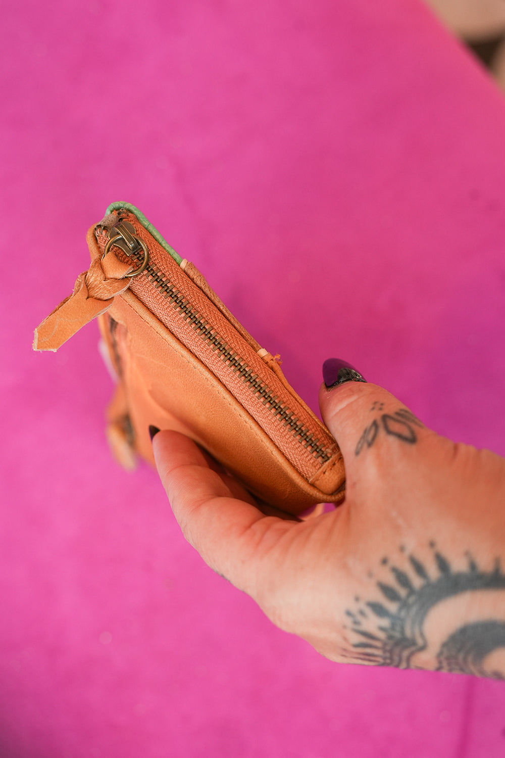 Meet the Sundown Sunglass Purse in Caramel, a handcrafted leather sunglass holder featuring a colorful desert sunset and cactus design.