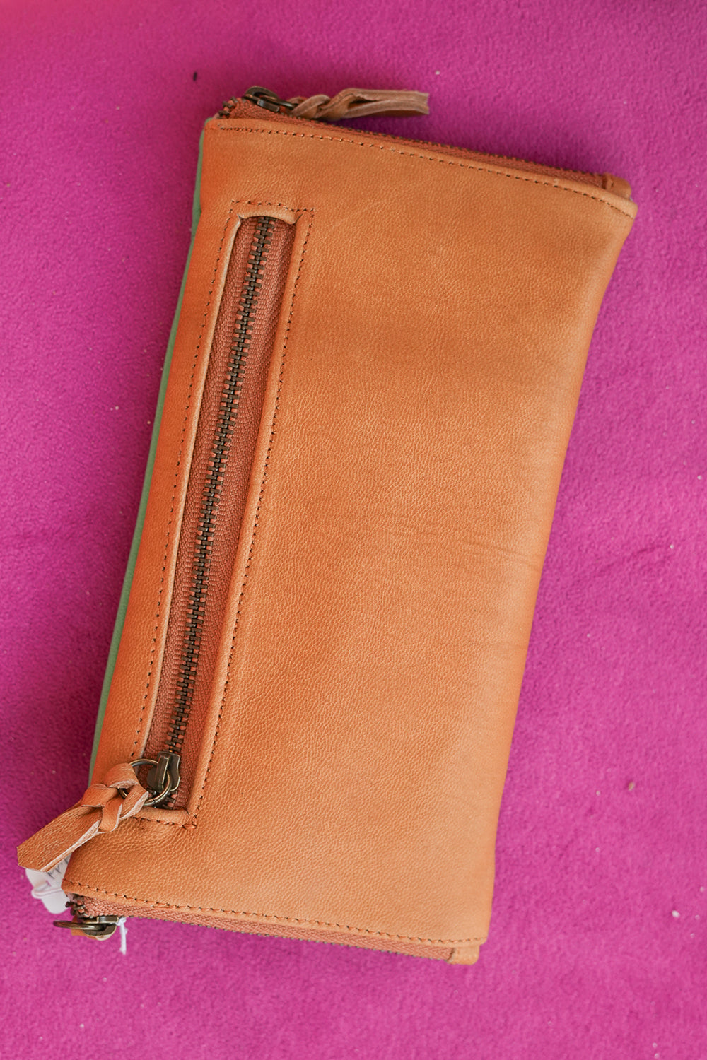 Meet the Sundown Sunglass Purse in Caramel, a handcrafted leather sunglass holder featuring a colorful desert sunset and cactus design.