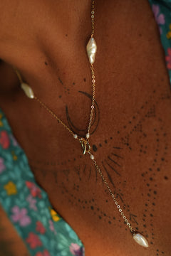 Shop the Tidal Lariat Necklace in Pearl Gold, featuring organic baroque pearls, fine gold chain and an elegant drop from Earth Altering by Jinx the Label.