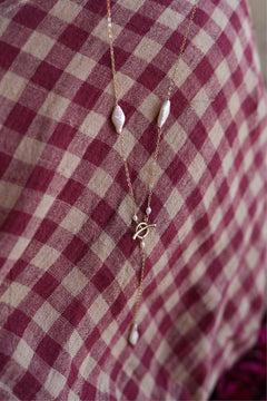 Shop the Tidal Lariat Necklace in Pearl Gold, featuring organic baroque pearls, fine gold chain and an elegant drop from Earth Altering by Jinx the Label.