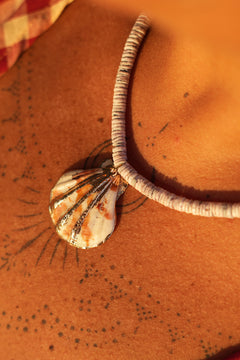 Shop the Tidal Treasure Necklace in Sunbleached Shell, featuring natural shell beads and a gold detailed shell pendant from Earth Altering by Jinx.