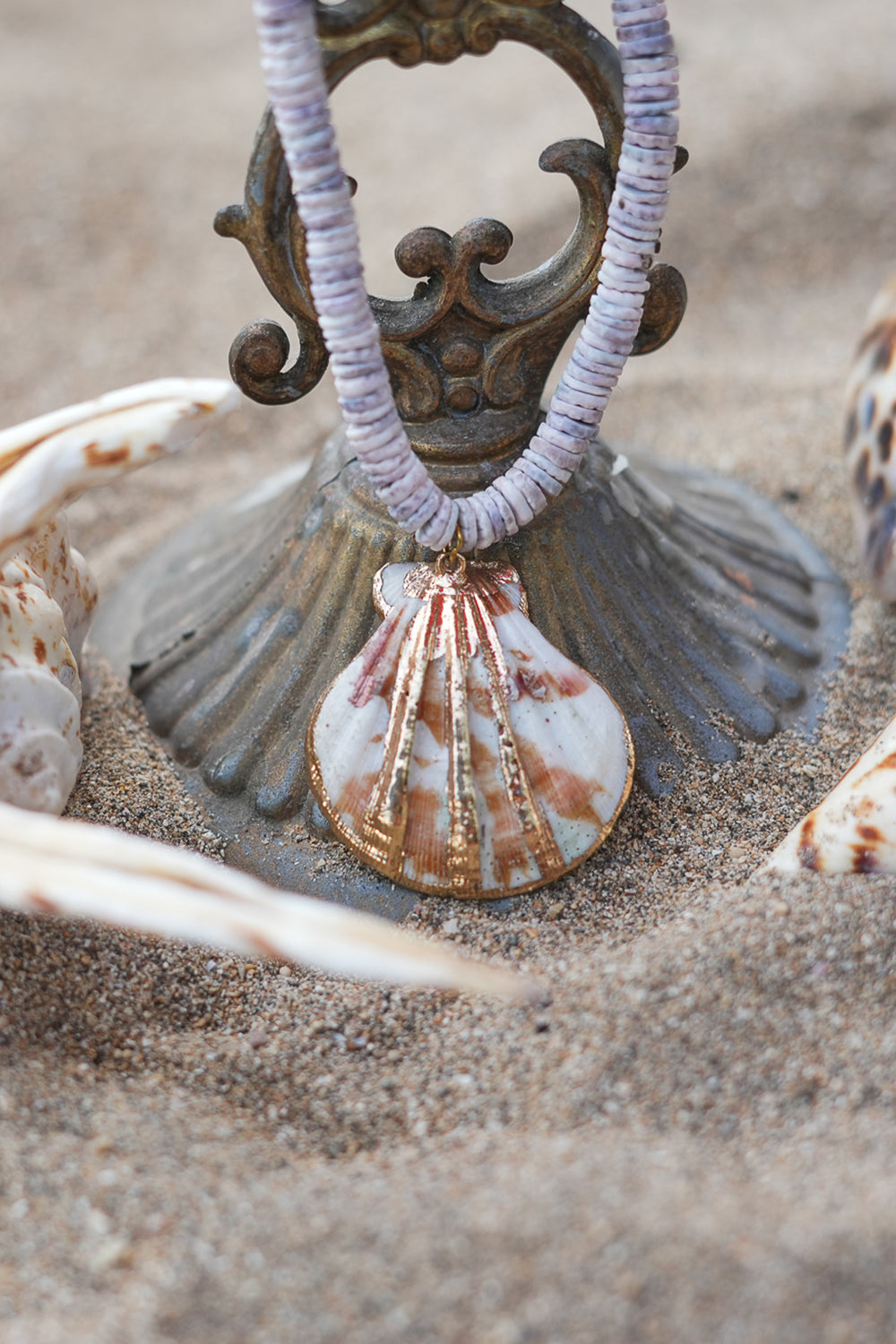 Shop the Tidal Treasure Necklace in Sunbleached Shell, featuring natural shell beads and a gold detailed shell pendant from Earth Altering by Jinx.
