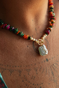 Shop the Wanderlust Necklace in Rainbow Pearl, with colorful chip beads, creamy pearls and a baroque pearl pendant from Earth Altering by Jinx the Label.