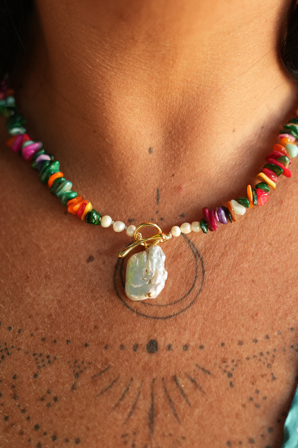 Shop the Wanderlust Necklace in Rainbow Pearl, with colorful chip beads, creamy pearls and a baroque pearl pendant from Earth Altering by Jinx the Label.