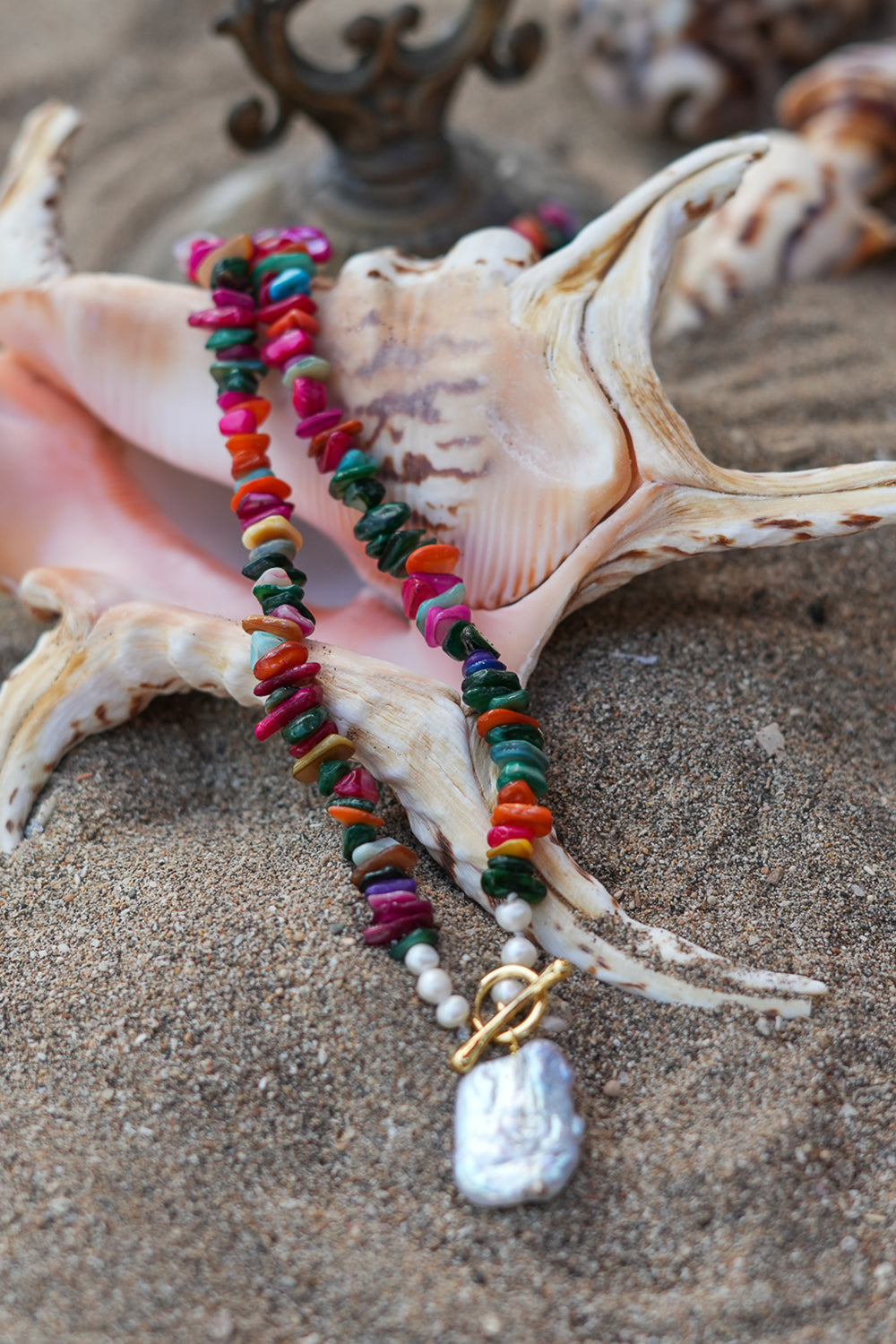 Shop the Wanderlust Necklace in Rainbow Pearl, with colorful chip beads, creamy pearls and a baroque pearl pendant from Earth Altering by Jinx the Label.