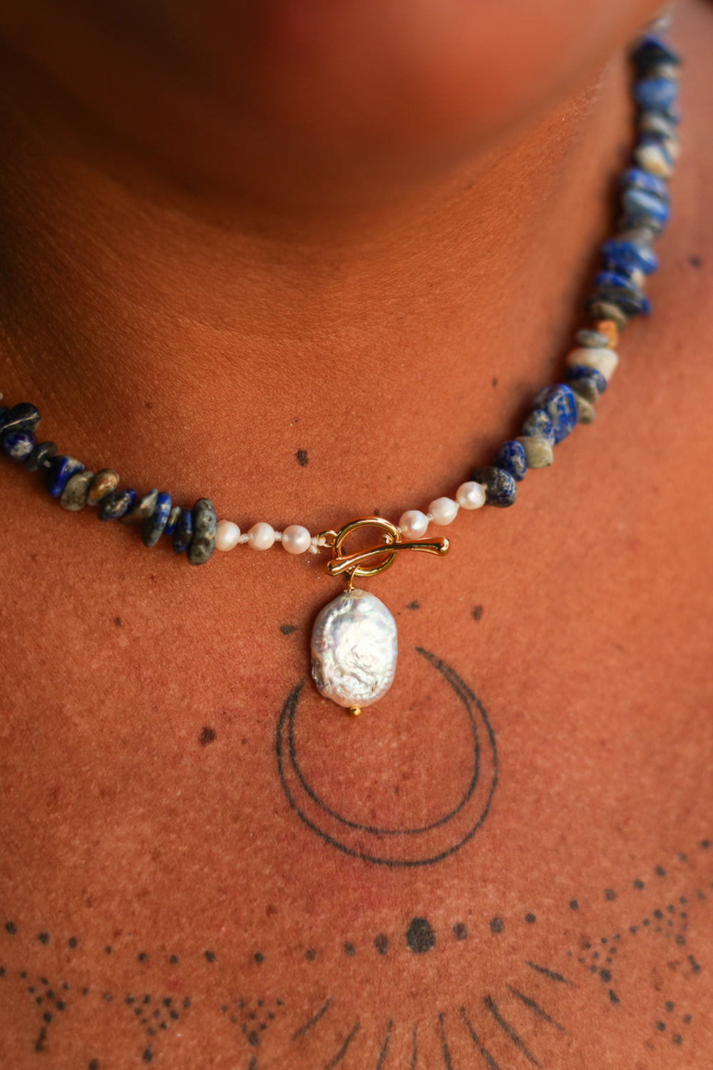 Discover the Wild Earth Necklace in Lapis Lazuli, featuring deep blue natural stones, freshwater pearls and a statement baroque pearl pendant by Jinx the Label.