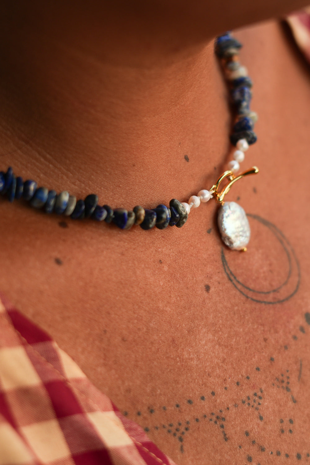 Discover the Wild Earth Necklace in Lapis Lazuli, featuring deep blue natural stones, freshwater pearls and a statement baroque pearl pendant by Jinx the Label.