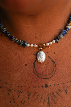 Discover the Wild Earth Necklace in Lapis Lazuli, featuring deep blue natural stones, freshwater pearls and a statement baroque pearl pendant by Jinx the Label.