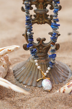 Discover the Wild Earth Necklace in Lapis Lazuli, featuring deep blue natural stones, freshwater pearls and a statement baroque pearl pendant by Jinx the Label.