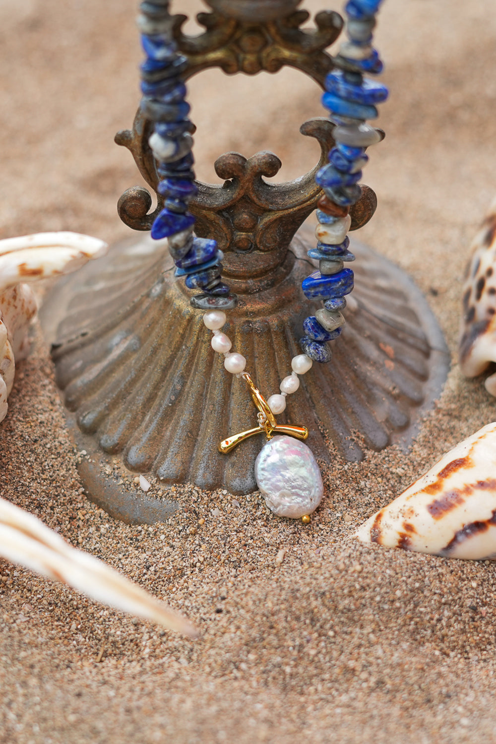 Discover the Wild Earth Necklace in Lapis Lazuli, featuring deep blue natural stones, freshwater pearls and a statement baroque pearl pendant by Jinx the Label.