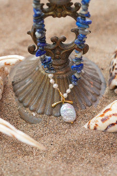 Discover the Wild Earth Necklace in Lapis Lazuli, featuring deep blue natural stones, freshwater pearls and a statement baroque pearl pendant by Jinx the Label.