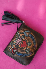 Meet the Wildheart Wallet in Burnished Espresso. A handcrafted leather zip wallet with hand tooled motives, card slots, a coin compartment and leather tassel.